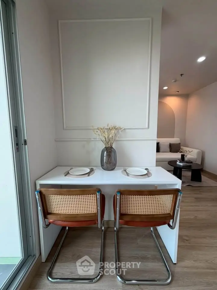 Modern dining nook with stylish chairs and elegant decor in a contemporary apartment.