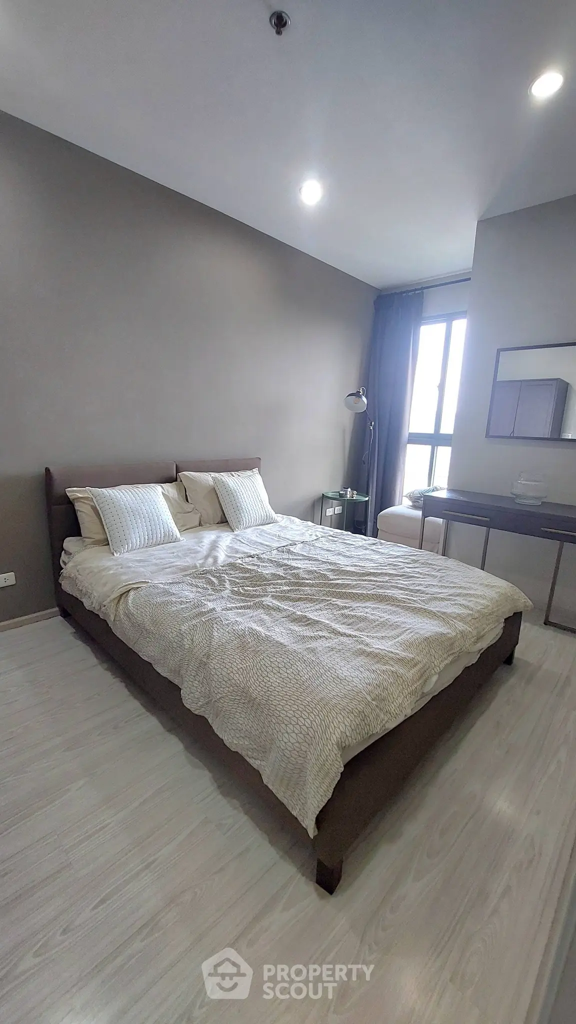 Modern bedroom with cozy bed and stylish decor in a contemporary apartment.