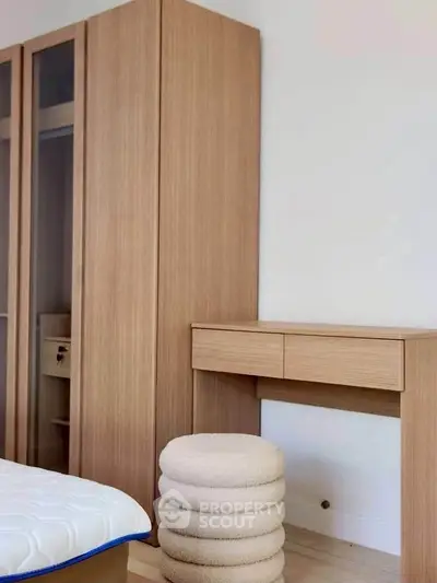 Modern bedroom with sleek wooden wardrobe and minimalist desk