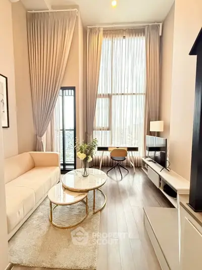 Luxurious high-ceiling living room with elegant decor and large windows for natural light.