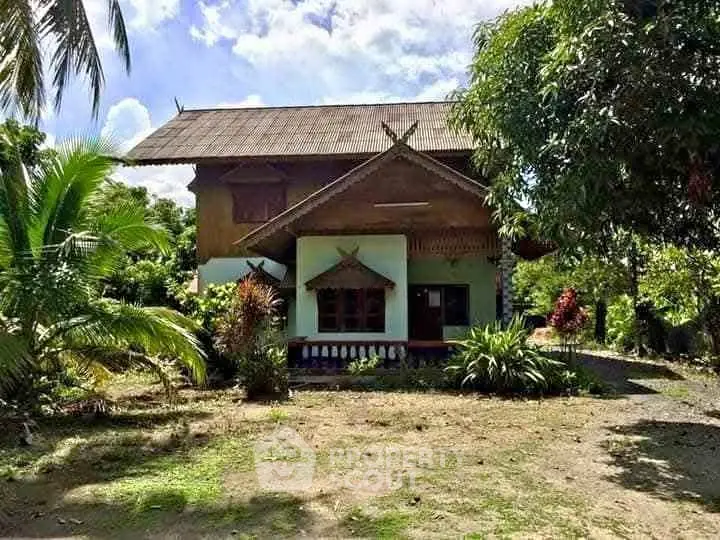 Charming rustic house with lush garden and traditional architecture.