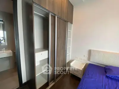 Modern bedroom with sleek wardrobe and cozy bed in stylish apartment.