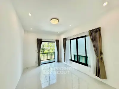 Bright and airy living room with large windows and balcony access, perfect for natural light lovers.