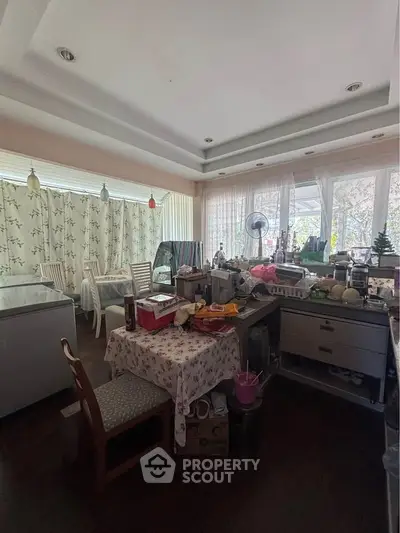Spacious kitchen with open layout and natural light, featuring modern appliances and dining area.