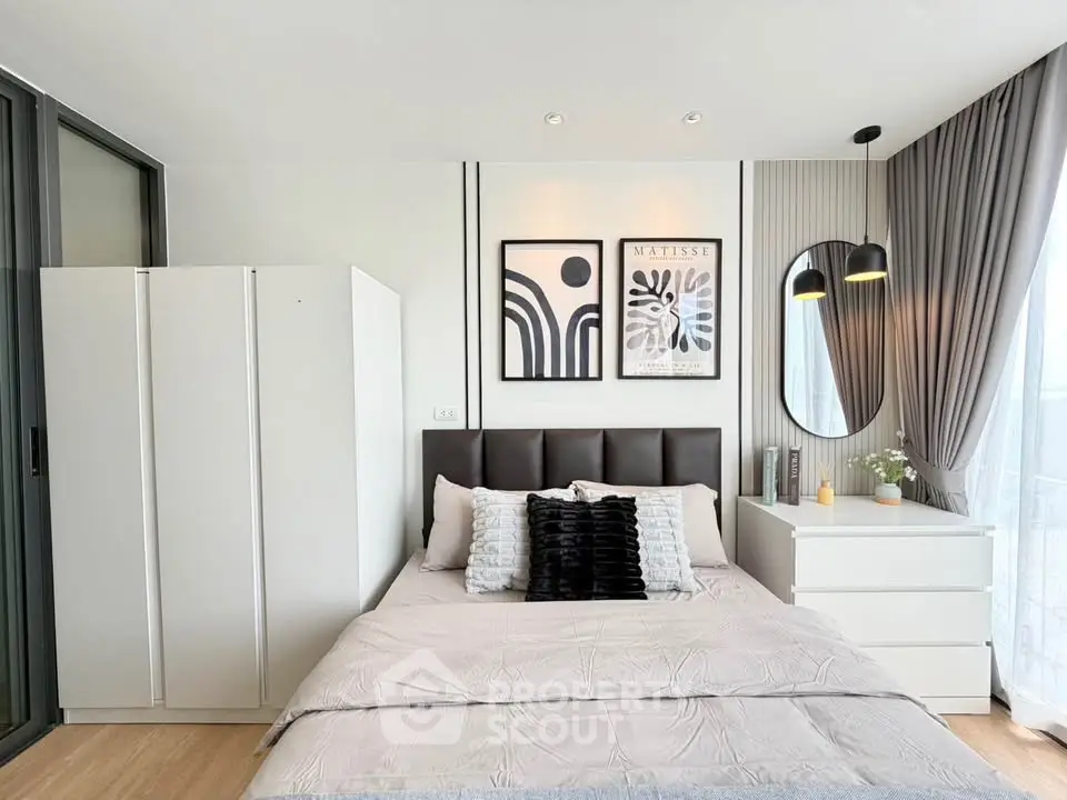 Modern bedroom with stylish decor, featuring a cozy bed, elegant lighting, and contemporary artwork.