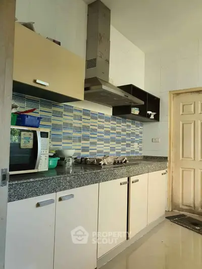 Modern kitchen with sleek cabinets and stylish backsplash