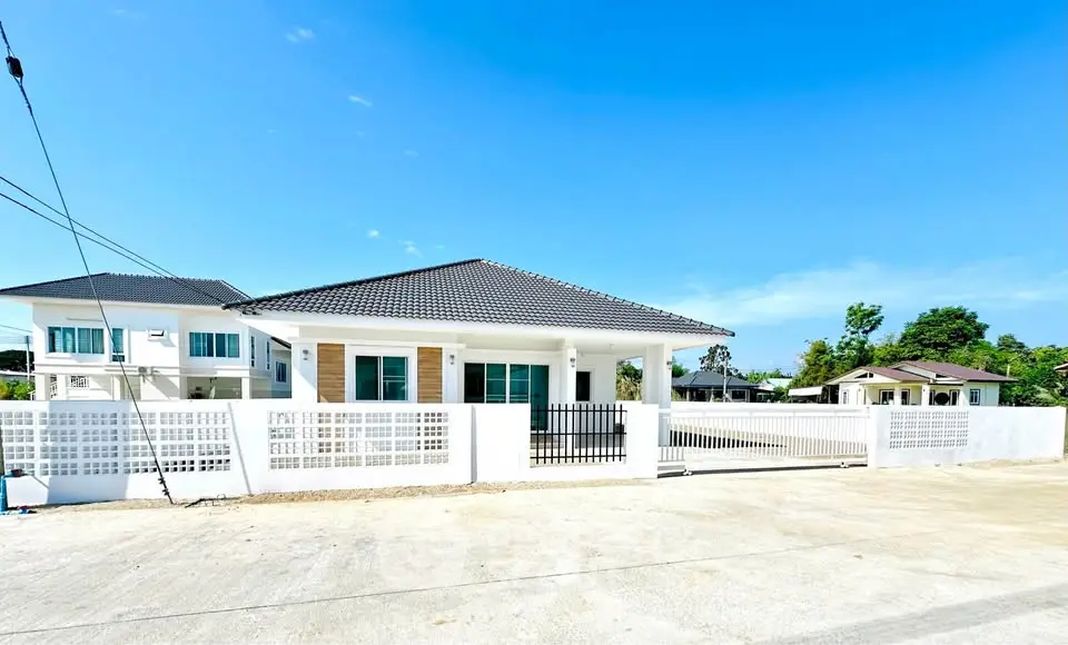 Charming single-story home with modern design and spacious front yard in a serene neighborhood.