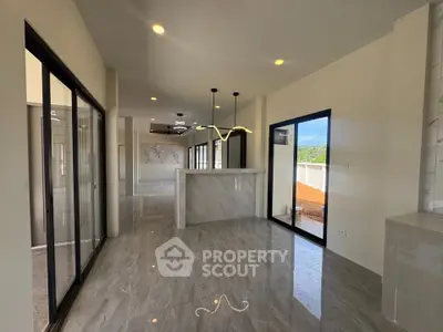 Modern open-plan living area with sleek marble flooring and stylish lighting fixtures.
