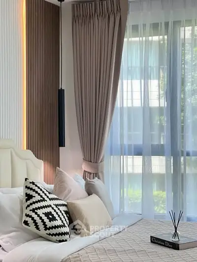 Luxurious bedroom with elegant decor and large window offering natural light