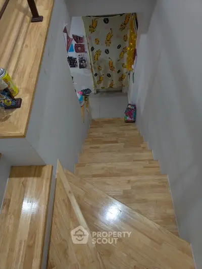 Stylish wooden staircase with decorative wall accents in modern home
