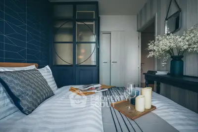 Stylish bedroom with modern decor and cozy ambiance, featuring elegant bedding and decorative accents.