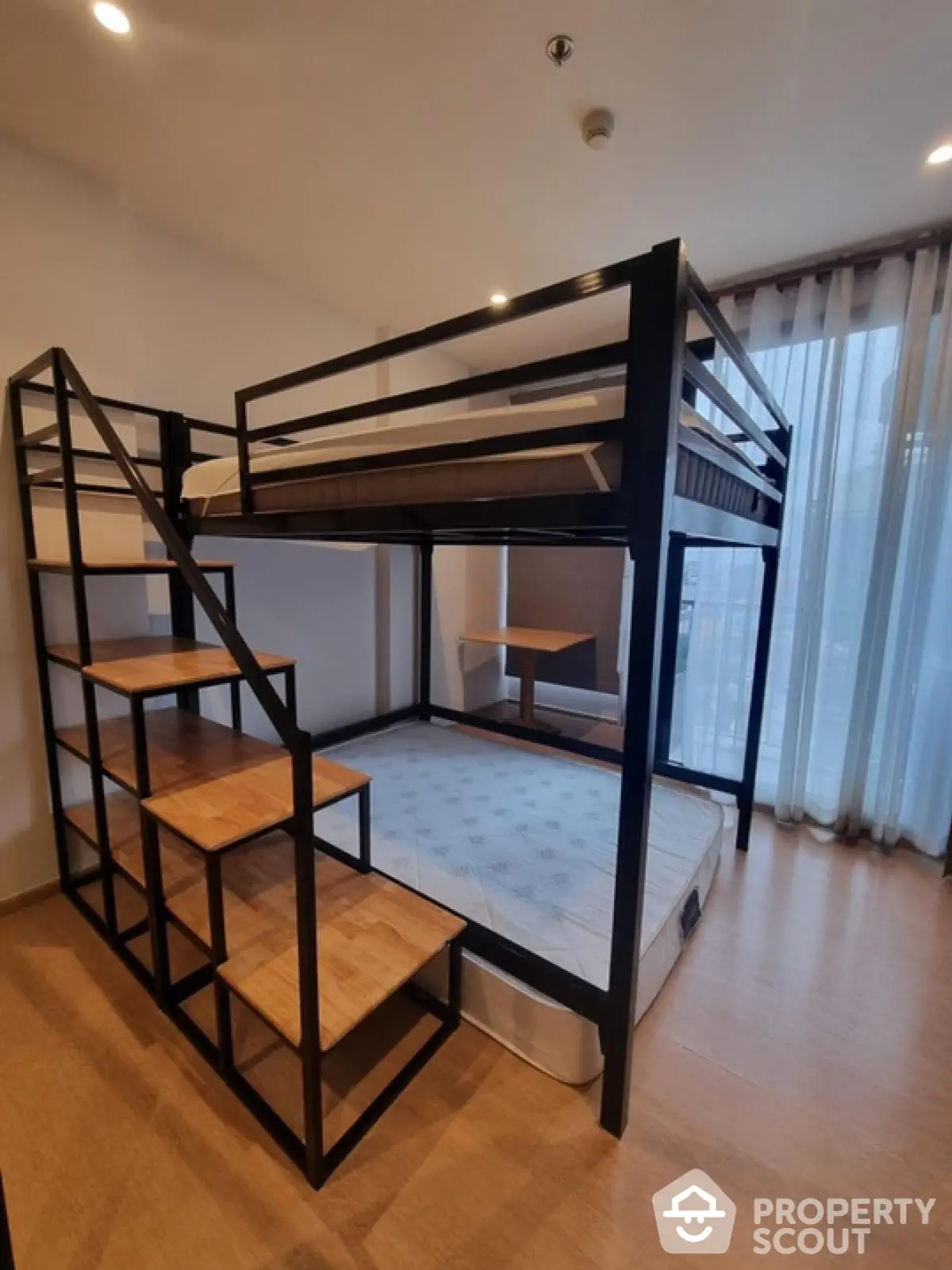 Modern bedroom with loft bed and large window for natural light