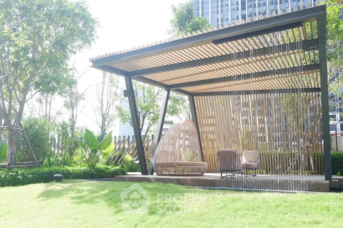 Modern garden gazebo with stylish seating and lush greenery, perfect for outdoor relaxation.