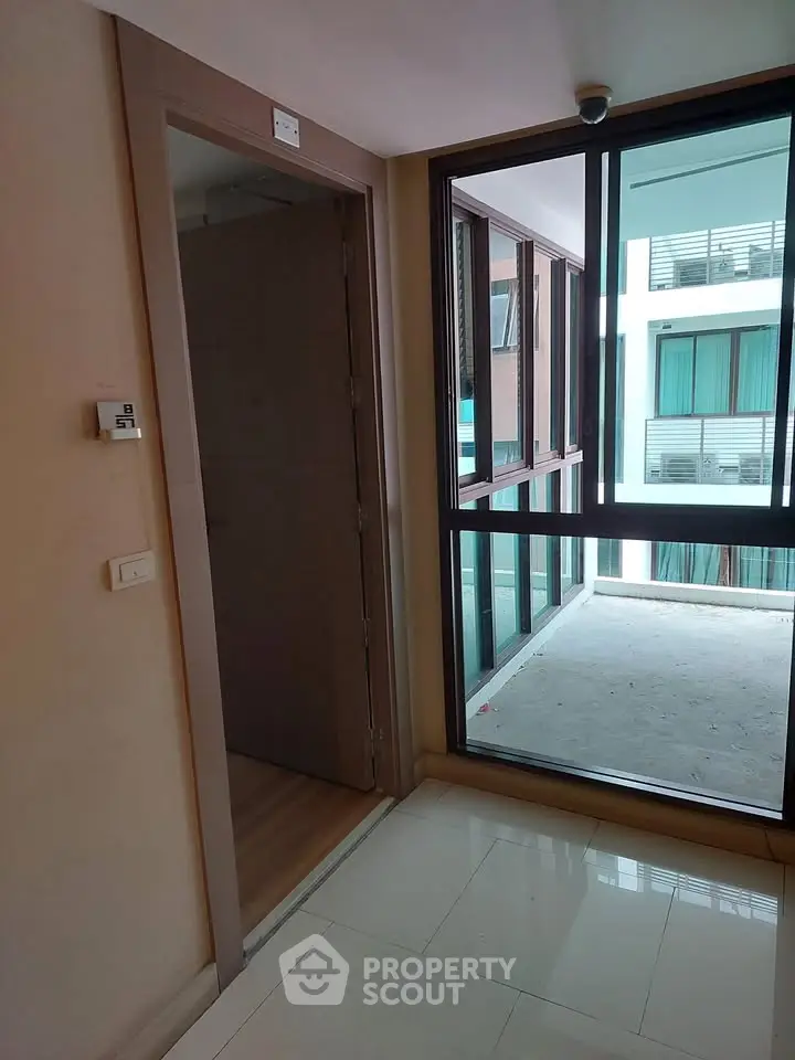Modern apartment corridor with large windows and sleek design