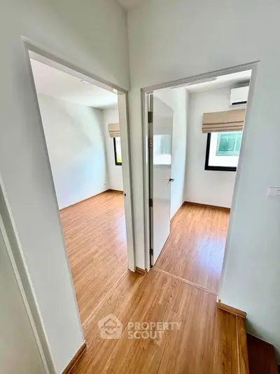 Bright and modern interior with wooden flooring and natural light in a residential unit.
