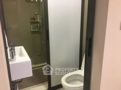 Modern bathroom with sleek design and glass shower enclosure.