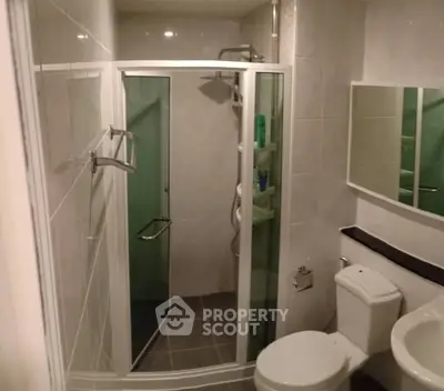 Compact bathroom with shower cabin and modern fixtures