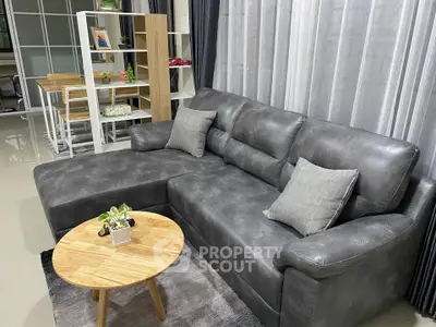 Modern living room with sleek gray sofa and stylish wooden coffee table, perfect for contemporary home decor.