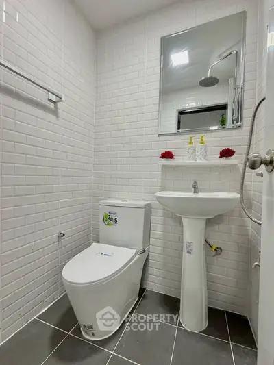 Modern bathroom with sleek white tiles and contemporary fixtures