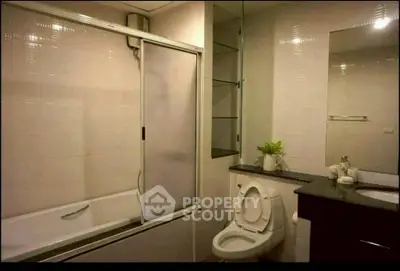 Modern bathroom with bathtub and sleek fixtures in a stylish apartment.