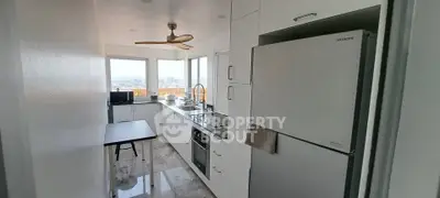 Modern kitchen with sleek appliances and panoramic city view