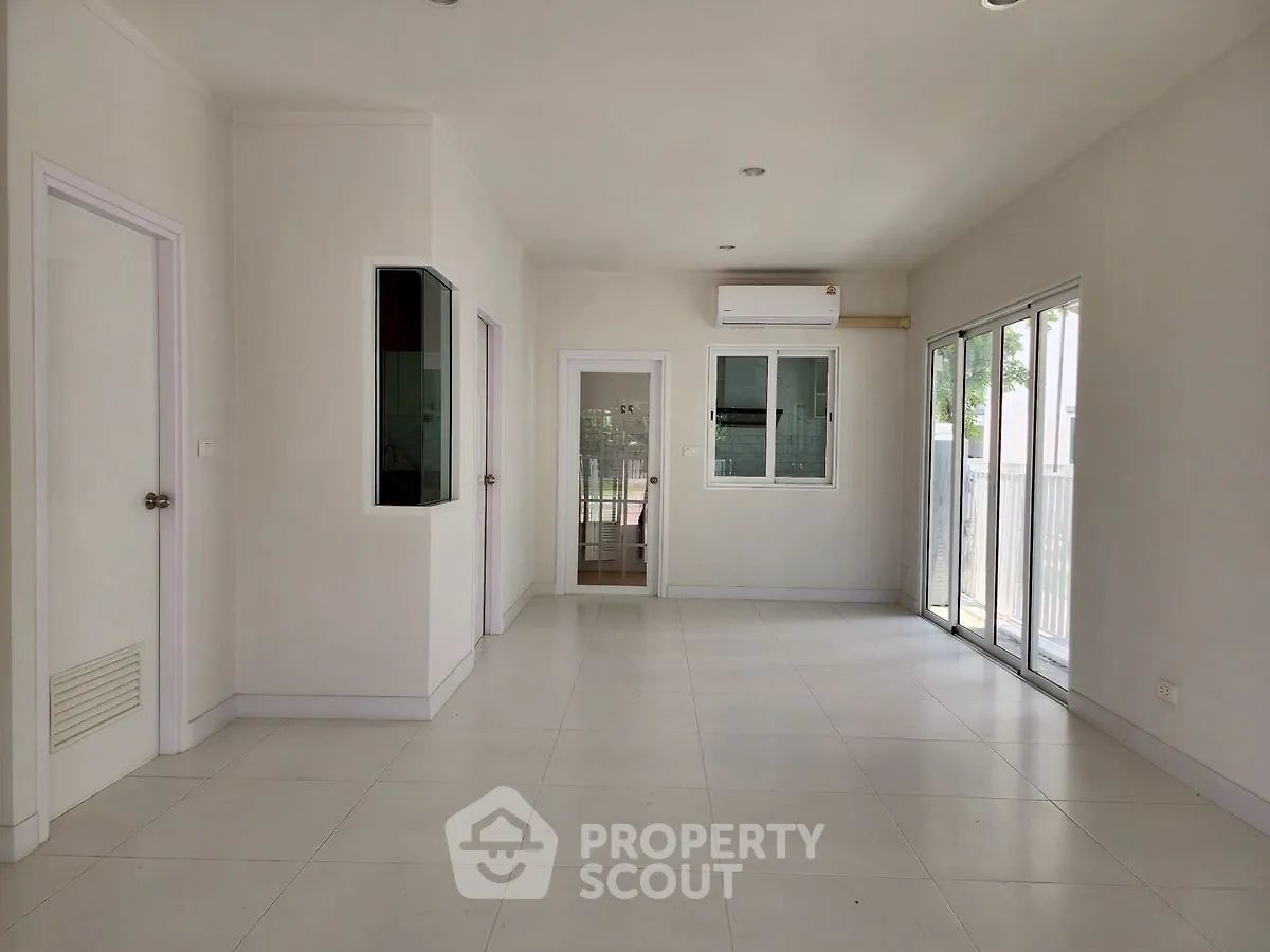 Spacious modern living room with large windows and air conditioning