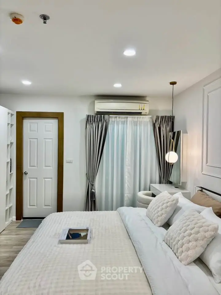 Modern bedroom with elegant decor and natural light, featuring a cozy bed and stylish curtains.