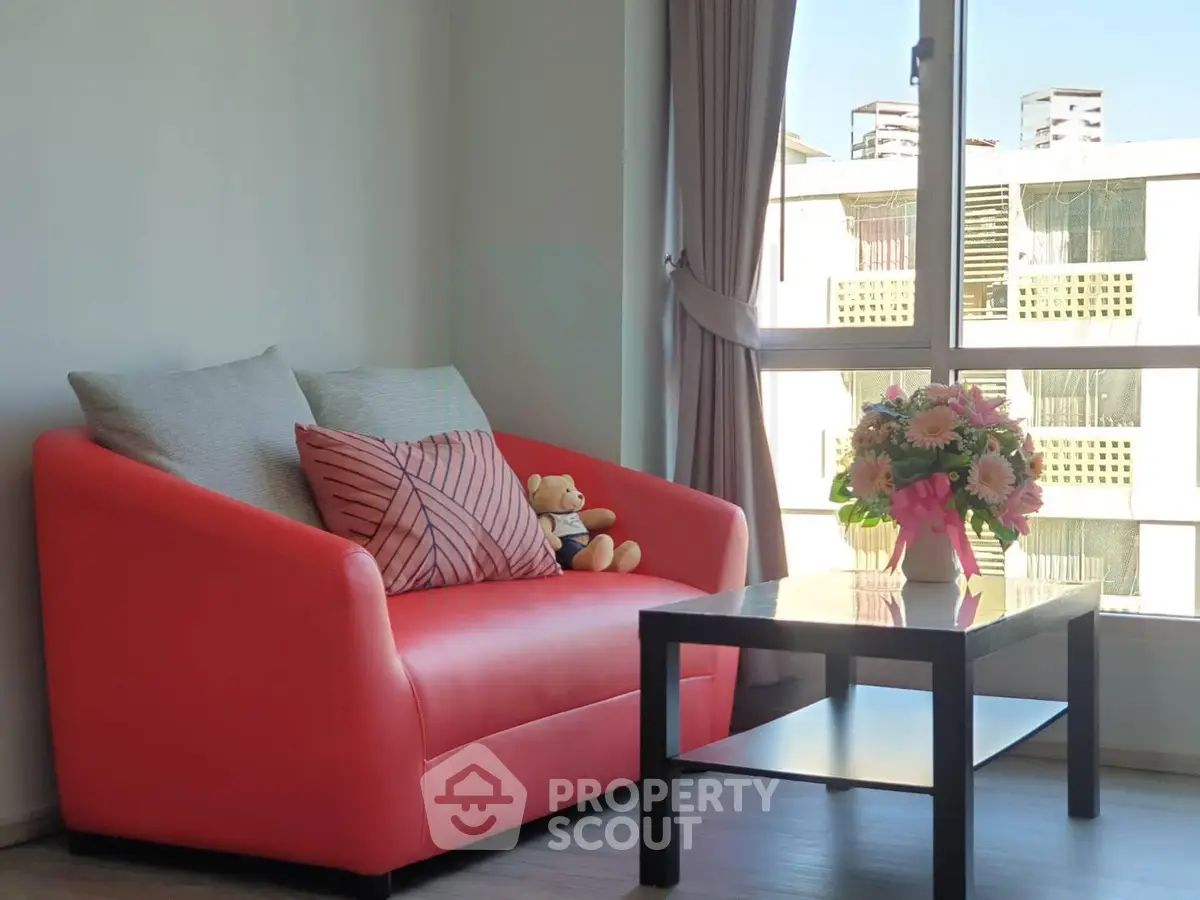 Cozy living room with red sofa and large window view