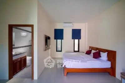 Spacious bedroom with ensuite bathroom and modern decor