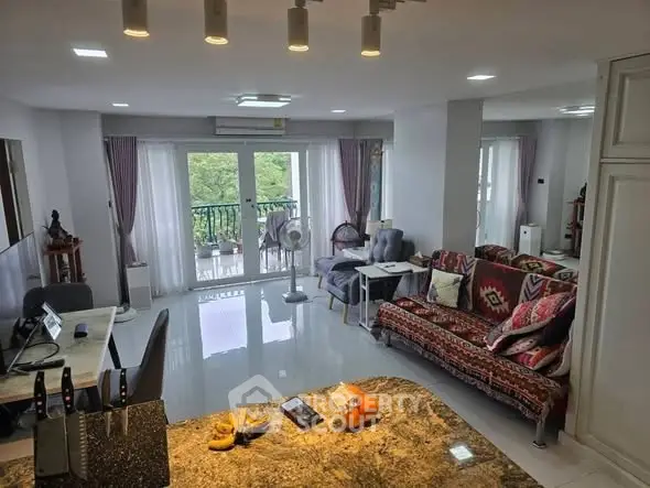 Spacious living room with modern decor and balcony view