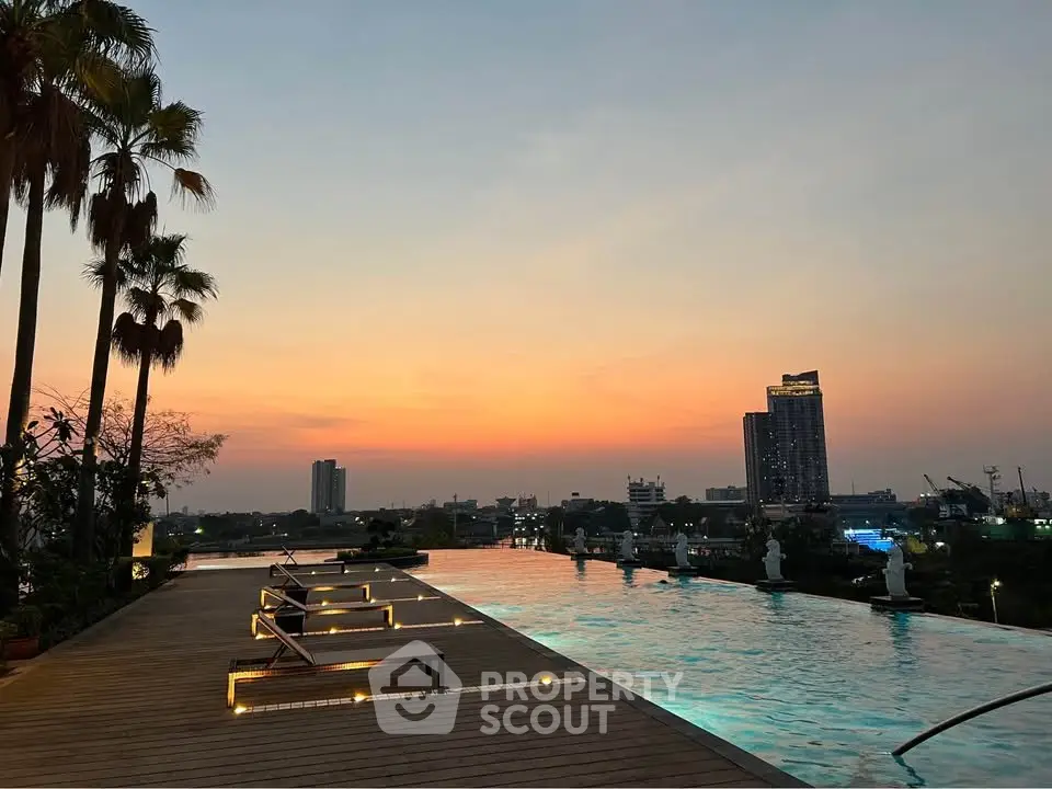 Luxurious rooftop pool with stunning sunset city view, perfect for relaxation and leisure.