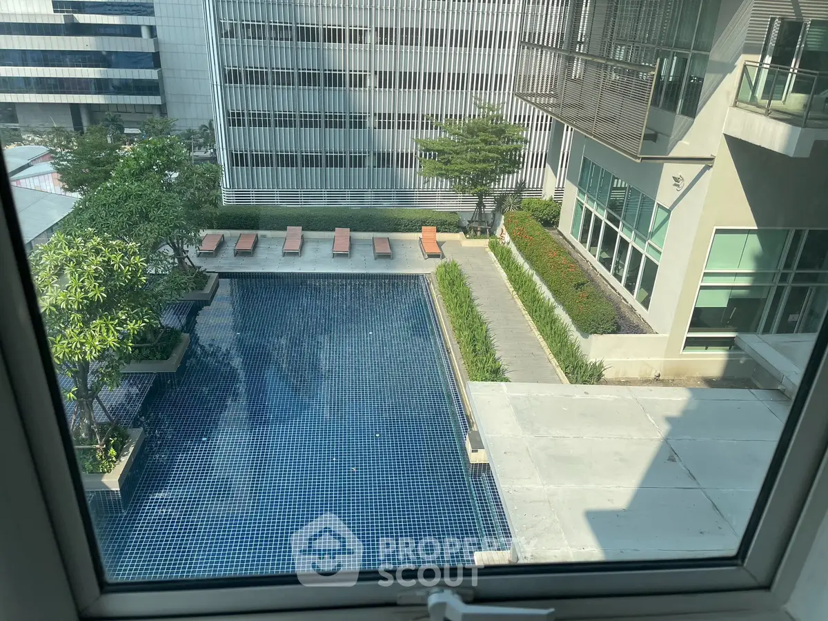 Luxurious apartment view with serene pool and modern architecture