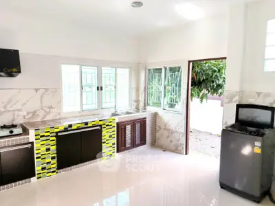 Bright modern kitchen with open layout and stylish tile accents