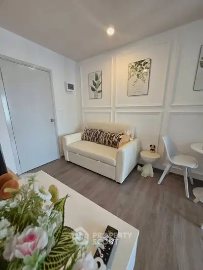 Charming living room with modern decor and cozy seating, perfect for relaxation and entertaining guests.
