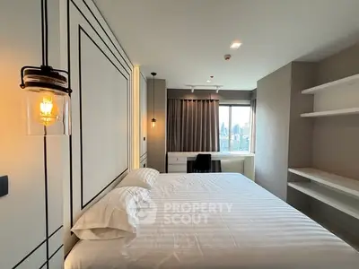 Modern bedroom with city view, featuring sleek design and ample natural light.