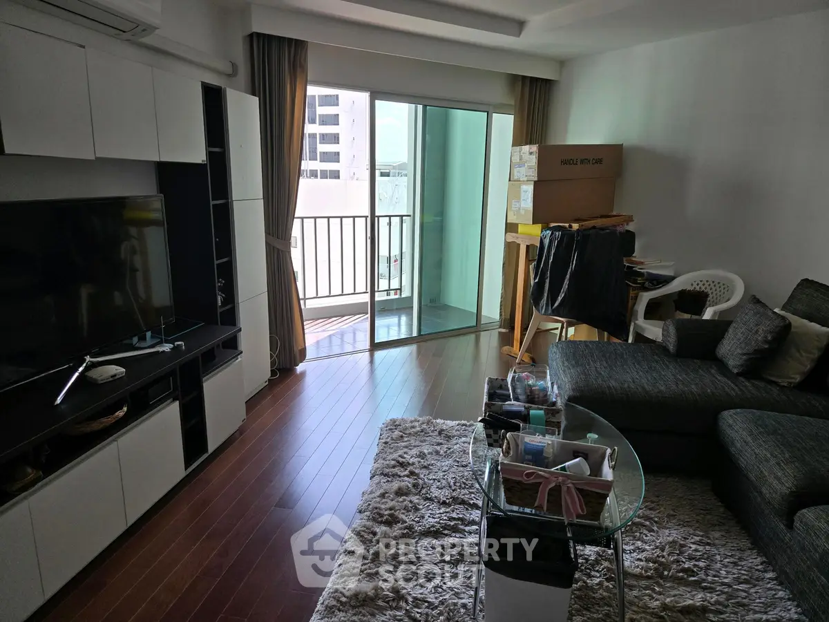 Spacious living room with modern decor and balcony access in a stylish apartment.