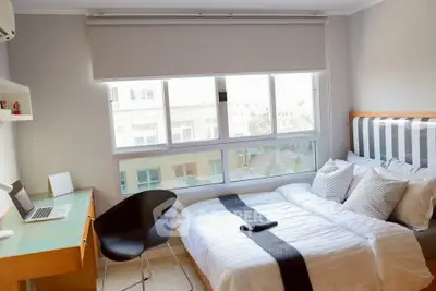 Bright and modern bedroom with large window and stylish decor