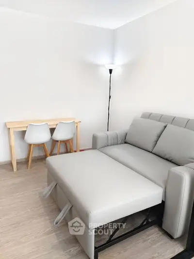 Modern living room with sleek sofa and minimalist desk setup