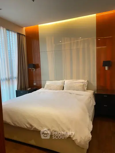 Luxurious bedroom with modern design and ambient lighting in high-rise apartment.