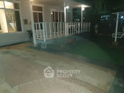 Charming home exterior with spacious patio and lush garden, perfect for outdoor relaxation.