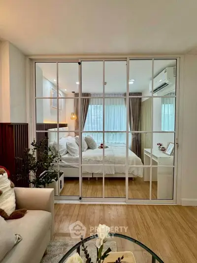 Elegant bedroom with glass sliding doors and cozy decor