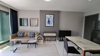 Modern living room with stylish decor and large windows in a contemporary apartment.