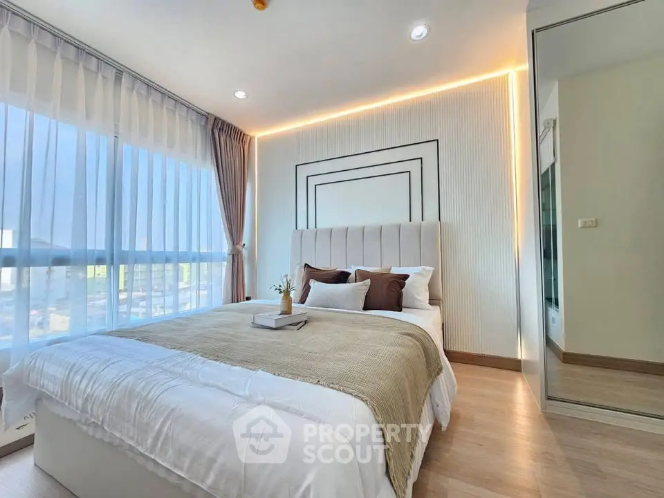 Luxurious bedroom with modern decor and large windows offering abundant natural light.