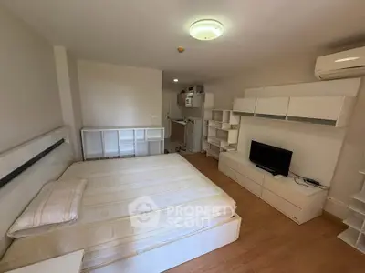 Modern studio apartment with built-in storage and compact kitchen