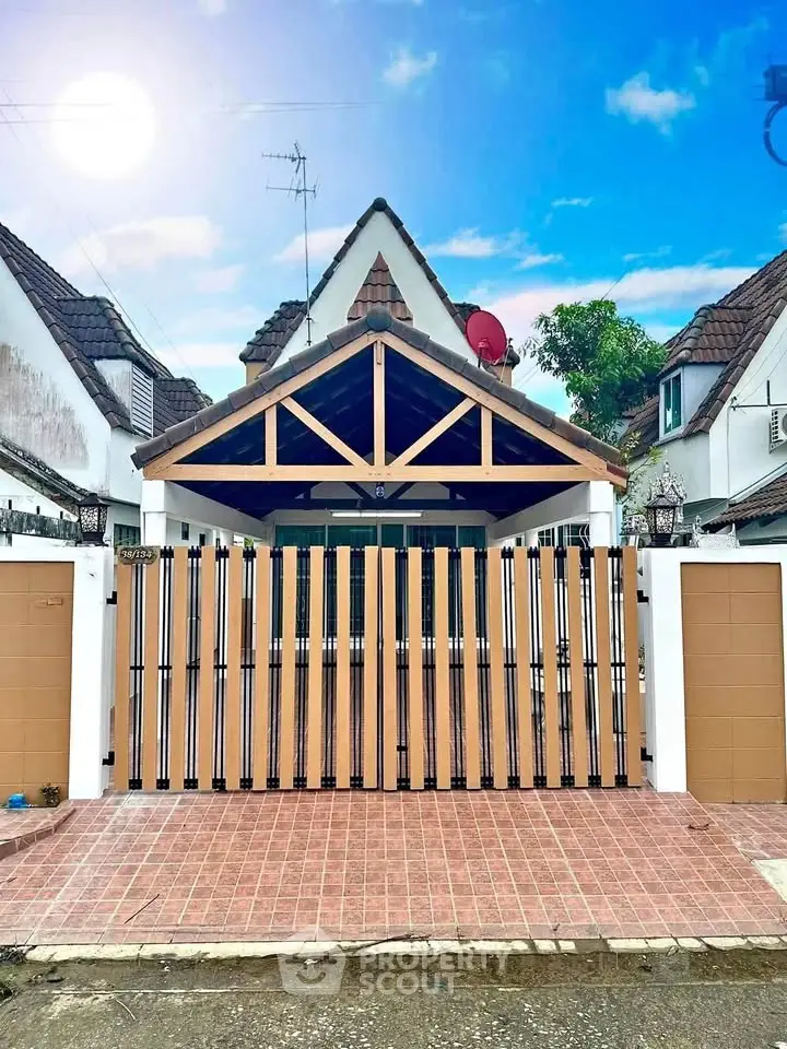 Charming suburban house with tiled roof and gated entrance, perfect for family living.