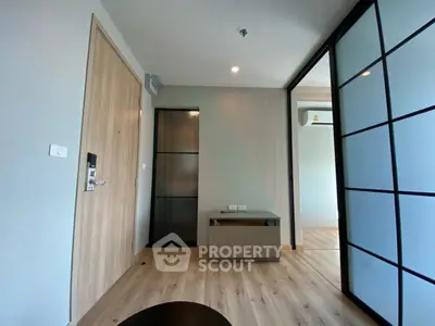Modern apartment interior with sliding glass doors and wooden flooring