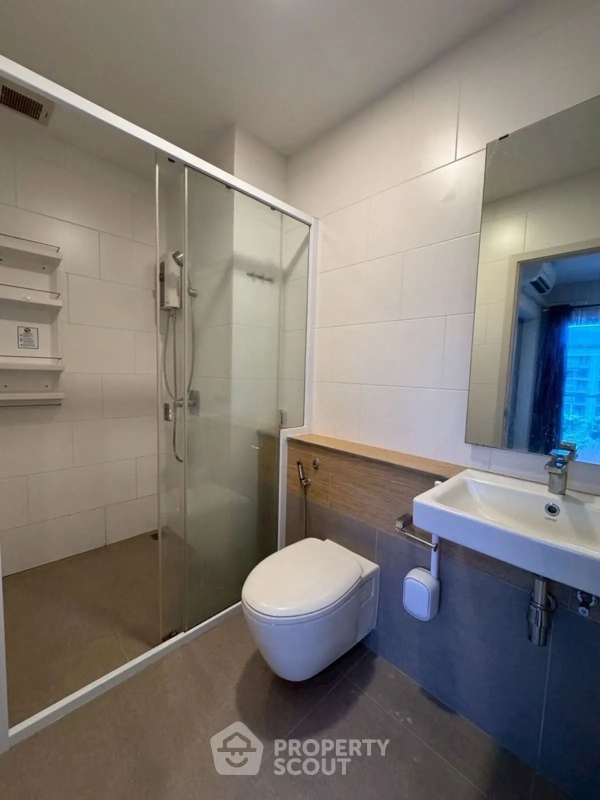 Modern bathroom with glass shower and sleek fixtures in a contemporary apartment.