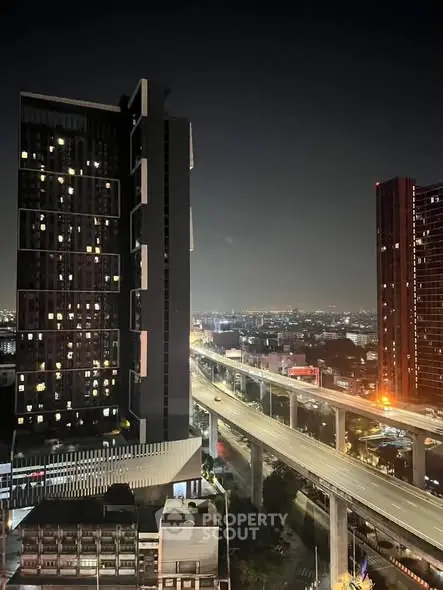 Stunning cityscape view from high-rise building at night with illuminated skyline.