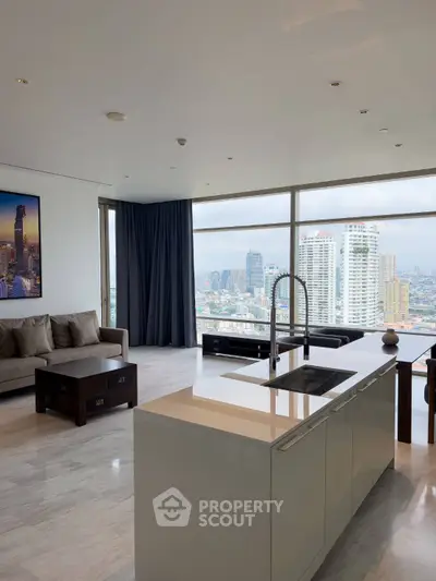 Luxurious open-plan living room with stunning city view and modern kitchen island.