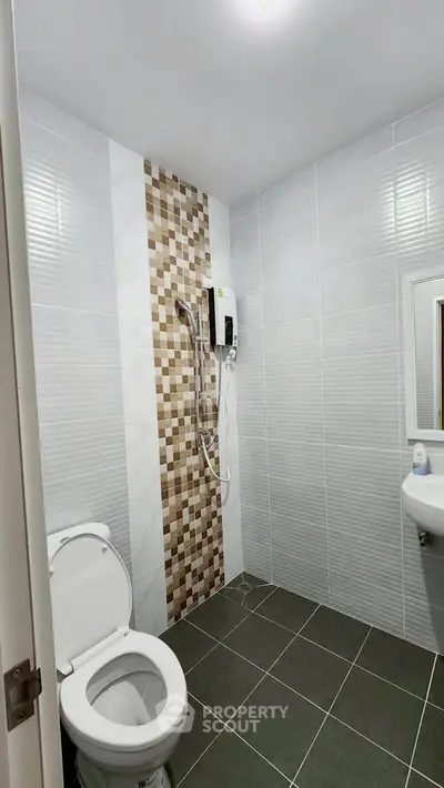 Modern bathroom with sleek tiles and shower in contemporary home